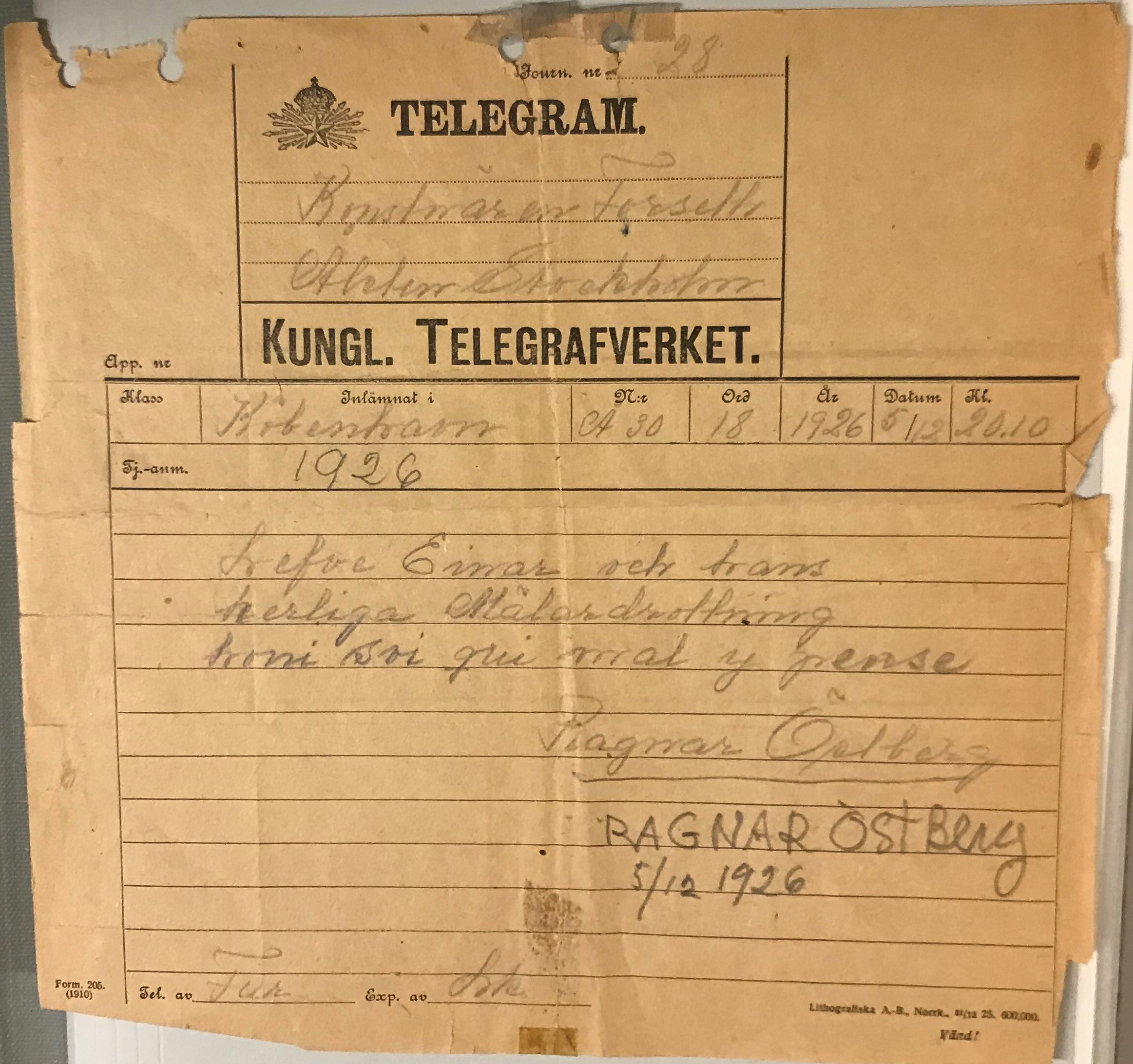 Telegram med tryckt rubrik och handskriven text i blyerts på brunt papper.