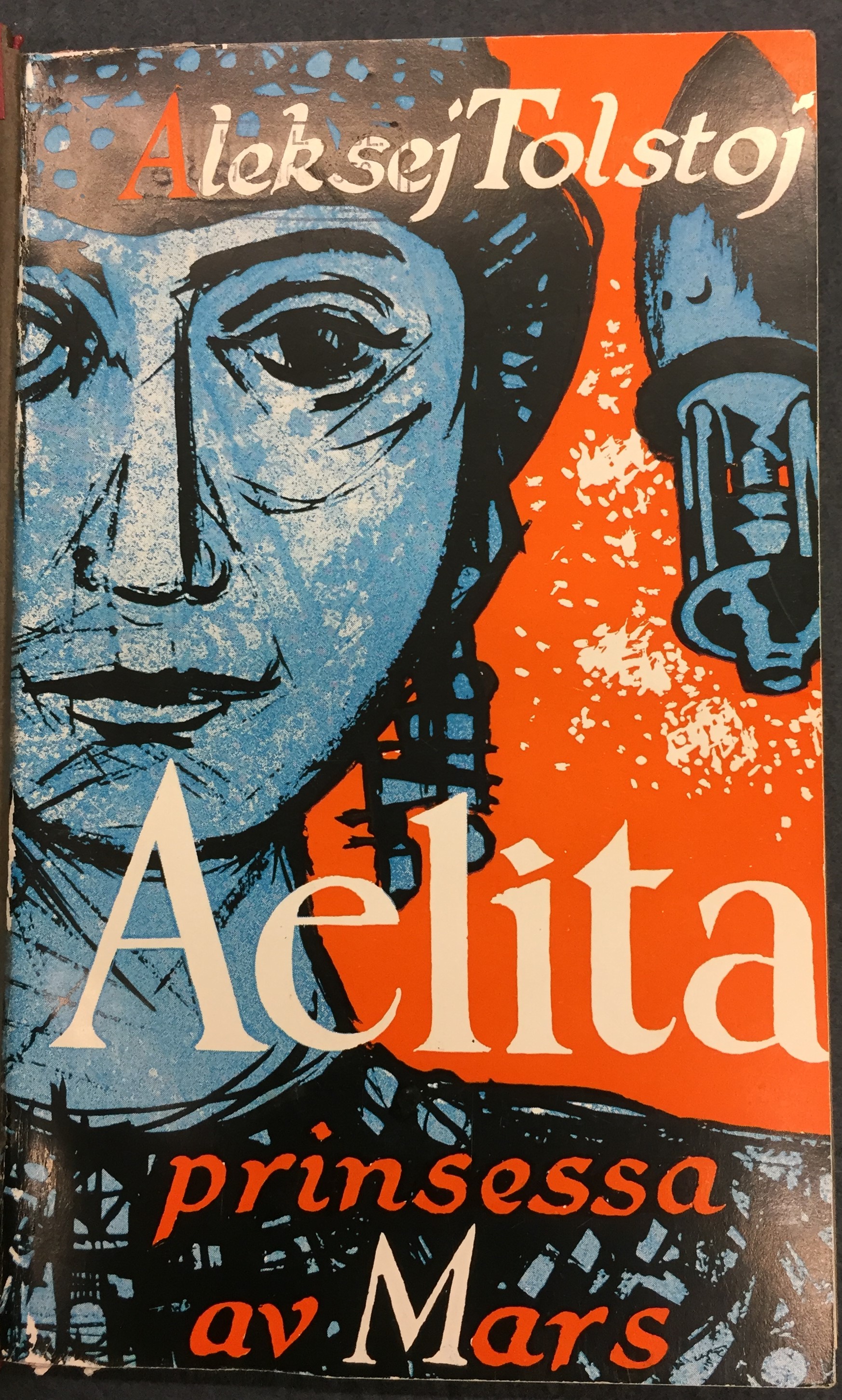 Omslag till Aelita. Kvinnoansikte och rymdraket i blått mot en orange bakgrund.