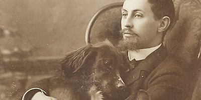 Peaceful photograph of a man with a dog on his lap.
