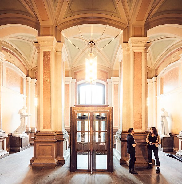Magnificent entrance with high arch, pillars and glass doors.